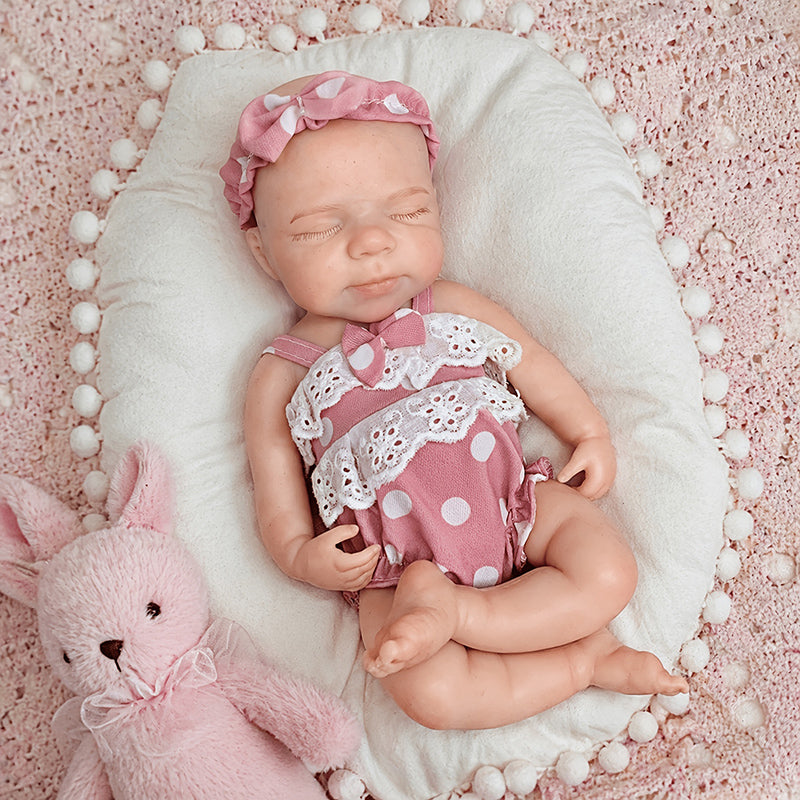 30 cm Pascale Reborn Puppe aus Vollsilikon mit geschlossenen Augen in rosa gepunkteter Kleidung