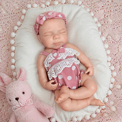 30 cm Pascale Reborn Puppe aus Vollsilikon mit geschlossenen Augen in rosa gepunkteter Kleidung