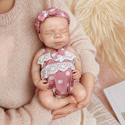 30 cm Pascale Reborn Puppe aus Vollsilikon mit geschlossenen Augen in rosa gepunkteter Kleidung