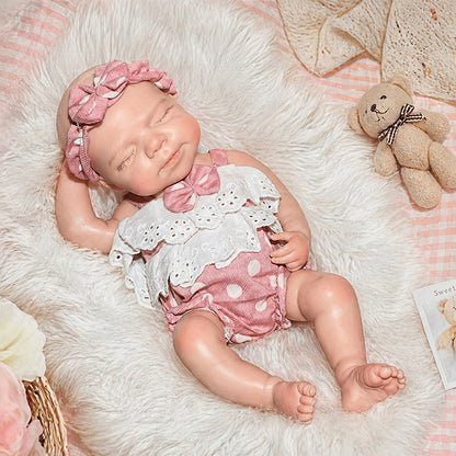 30 cm Pascale Reborn Puppe aus Vollsilikon mit geschlossenen Augen in rosa gepunkteter Kleidung