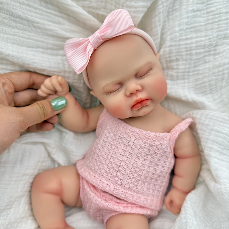 30 cm vollständig aus Silikon gefertigte Reborn Puppe Pickle mit geschlossenen Augen in rosa Outfits