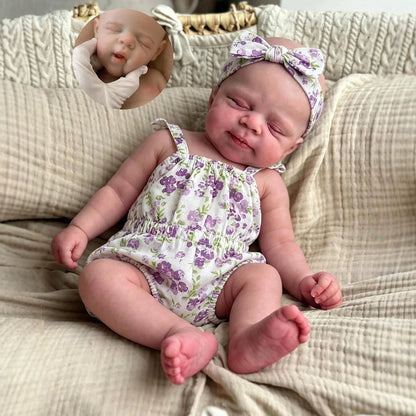 30 cm Pascale Reborn Puppe aus Vollsilikon mit geschlossenen Augen im lila geblümten Strampler