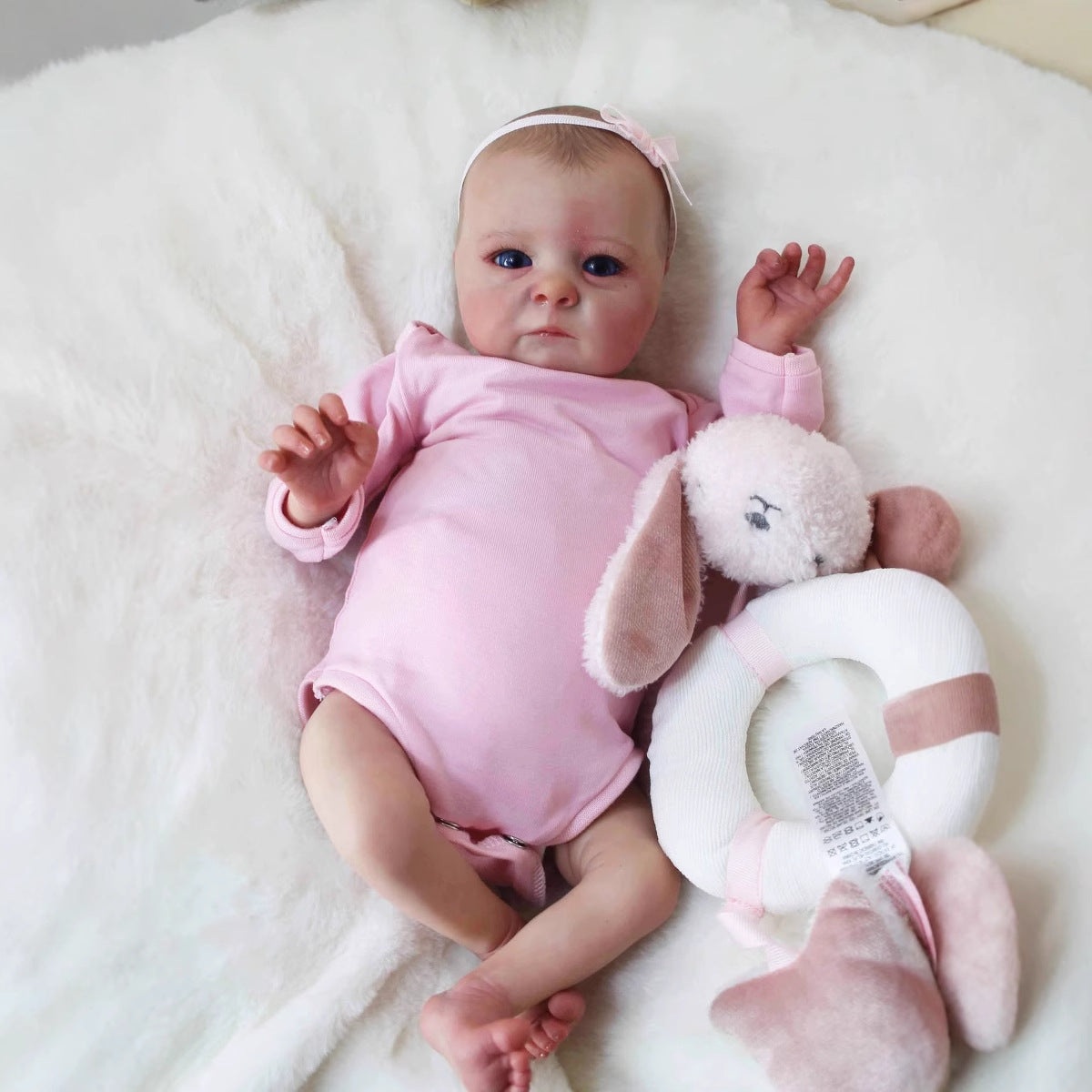 40 cm realistische Reborn-Puppe mit offenen Augen Tink in rosa Kleidung