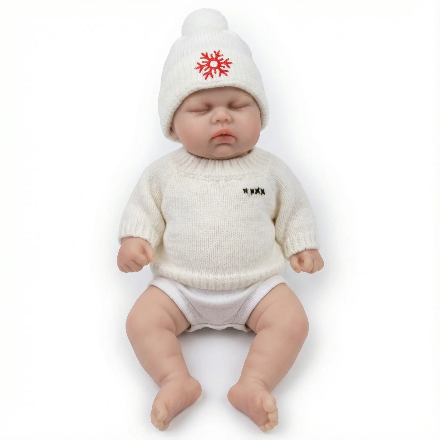 30 cm Reborn-Puppe Pickle aus Vollsilikon mit geschlossenen Augen im weißen Pullover