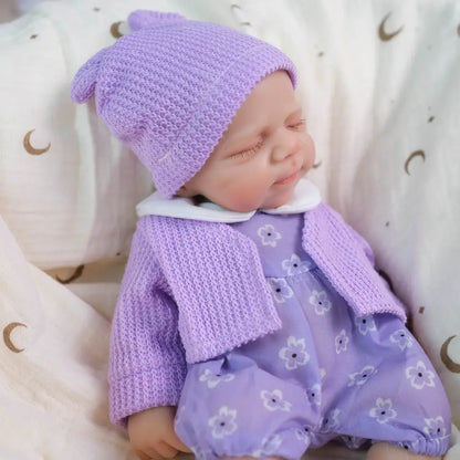 30 cm Pascale Reborn-Puppe aus Vollsilikon mit zu öffnendem Mund in lila Kleidung