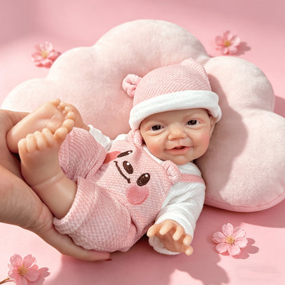 30 cm lebensechte Charlie Reborn-Puppe mit blauen Augen und einem strahlenden Lächeln aus Vollsilikon in rosa Bärenkleidung