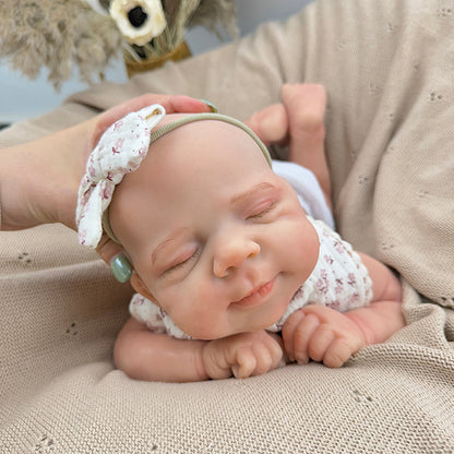 45cm dehnbares schlafendes Pascale Reborn Baby aus Vollsilikon mit Lätzchen mit Blumenmuster