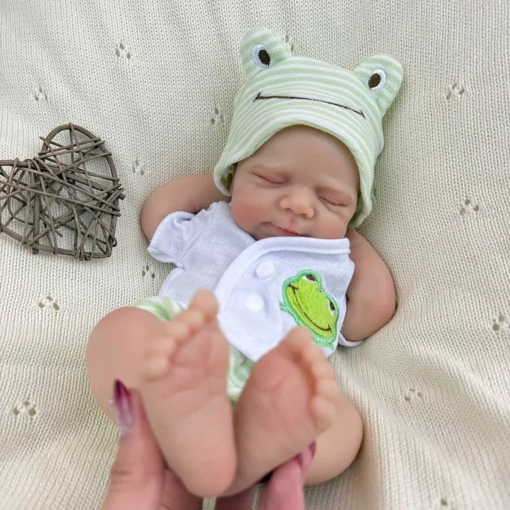 30 cm Pascale Reborn Puppe aus Vollsilikon mit geschlossenen Augen in grüner Froschkleidung