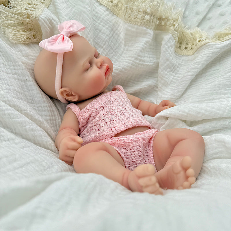 30 cm vollständig aus Silikon gefertigte Reborn Puppe Pickle mit geschlossenen Augen in rosa Outfits