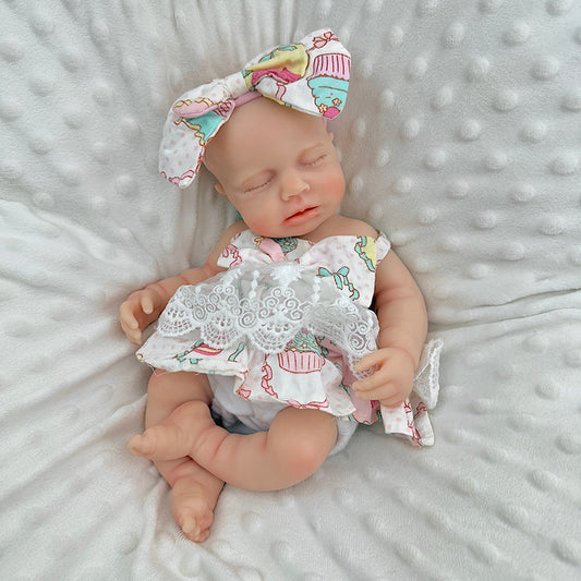 30cm Loulou Reborn Baby aus Vollsilikon mit geschlossenen Augen in einem Spitzenkleid mit Blumenmuster