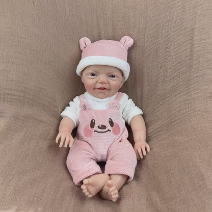 30 cm lebensechte Charlie Reborn-Puppe mit blauen Augen und einem strahlenden Lächeln aus Vollsilikon in rosa Bärenkleidung